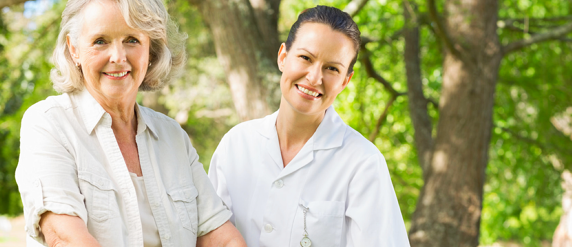 elderly woman smiling with her caregiver
